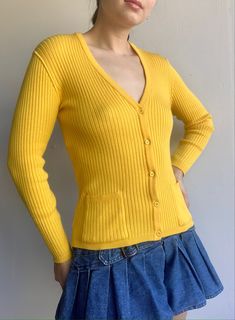 Courreges Vintage 70's Mustard Ribbed Sweater  Size: Tag says P, fits like a XS Condition: Good Used Vintage Condition, two light stains - see photos Fitted V-neck Cardigan With Pockets, Classic Fitted Sweater With Pockets, Retro Fitted Sweater For Work, Retro Ribbed Sweater For Spring, Classic Ribbed Fitted Outerwear, Classic Fitted Ribbed Outerwear, Vintage V-neck Fitted Outerwear, Vintage Fitted V-neck Outerwear, Yellow Fitted V-neck Cardigan