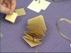 someone is making origami pieces out of paper