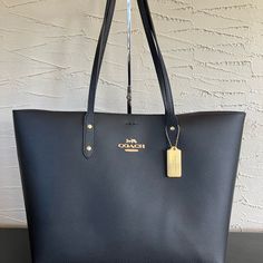 ~Nwt~ Coach City Tote In Black Leather 72673 Pristine Nwt Coach City Tote In Black Leather; Two Straps.Beautiful Smooth Oxblood Interior. Heavy Brass Hang Tag - No Scratches Or Surface Wear. Magnetic Closure. Inside Zip Pocket. Protective Wraps On Zipper Pull And One Side Of Magnet, As Well As Protective Foam Under The Creed Patch. Gold Metal Pinmounted Logo On Exterior And Interior Please See Photos For Measurements. Please Message Me With Any Questions. I Usually Ship Within One Day, Or Ship Within Two Days At The Most. City Tote, Black Leather, Nwt, Carry On, Travel, Work, Work Bag, Weekend, Weekender, Travel, Classic, Leather, Winter, Spring, Summer, Fall, Modern, Feminine, Vac Coach City Tote, Carry On Travel, City Tote Bag, Black Poppy, Coach Tote Bags, Modern Feminine, Travel Work, Brown Handbag, White Tote