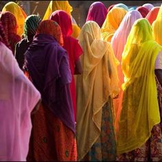 a group of women in brightly colored sari