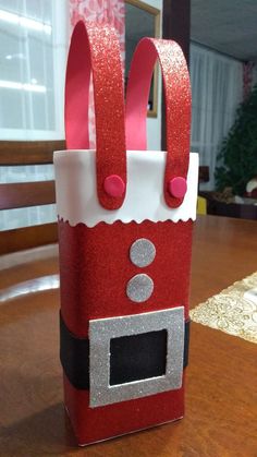 a red and white bag sitting on top of a wooden table