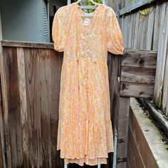 Olivaceous Pierre Peach Midi Dress Size Large 100% Cotton Lining: 100% Rayon Never Been Worn; Tags Still Attached Peach Floral Print Midi Dress, Peach Midi Dress For Spring, Apricot Short Sleeve Dress For Vacation, Peach Floral Print Midi Dress With Short Sleeves, Peach Floral Print Short Sleeve Midi Dress, Spring Apricot Midi Dress For Beach, Orange Feminine Dresses For Daywear, Peach Floral Print Midi Dress For Vacation, Peach Floral Print V-neck Midi Dress