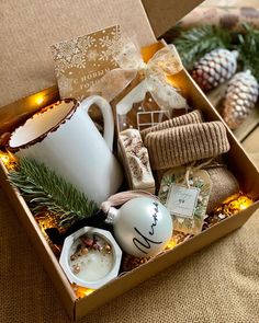 a box filled with assorted items on top of a table next to a christmas tree