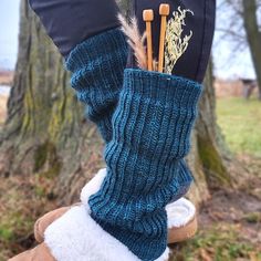 the legs of a person wearing boots with knitted socks and leg warmers on