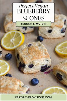 blueberry scones on a baking sheet with lemons and blueberries in the background