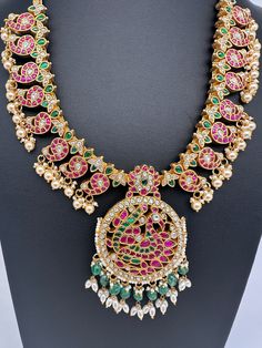 Jadau Kundan Peacock Mango MidLenght Necklace with matching EarringsColor : GoldenSize : Necklae Length : 20 Inches; No EarringsStones : Jadau Kundan Pearls Emerald Beads Multicolor Peacock Design Temple Jewelry, Multicolor Peacock Temple Jewelry, Multicolor Peacock Design Temple Necklace, Multicolor Bridal Necklace With Peacock Design For Celebration, Fusion Style Peacock Design Necklace For Wedding, Peacock Colored Jewelry For Weddings And Festivals, Multicolor Peacock Design Temple Jewelry Sets, Festive Fusion Style Necklace With Peacock Design, Festive Fusion Style Peacock Design Necklaces