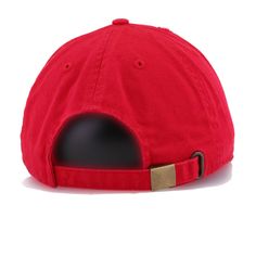 a red hat with a black hole in the middle and a gold buckle on it