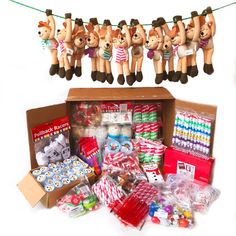 a box filled with lots of toys and other items next to a string of christmas decorations