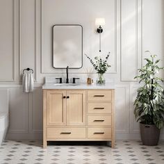 a bathroom with a sink, mirror and potted plant