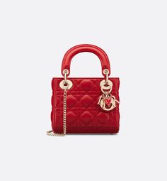 Part of the Dioramour capsule, the Lady Dior bag embodies the House's vision of elegance and beauty. Sleek and refined, the timeless design is crafted in red lambskin with Cannage stitching, creating the instantly recognizable quilted texture. The silhouette is elevated by pale gold-finish metal D.I.O.R. charms and a red enamel heart charm. The miniature style has a thin, removable chain strap, allowing it to be carried by hand or worn crossbody. It will coordinate well with other Dioramour crea Lady Dior Mini, Mini Lady Dior, Lady Dior Handbag, Dior Star, Dior Book Tote, Dior Handbags, Wallet Pouch, Backpack Tote Bag, Beach Accessories