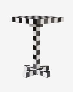 a black and white checkerboard table with two pedestals on each one side