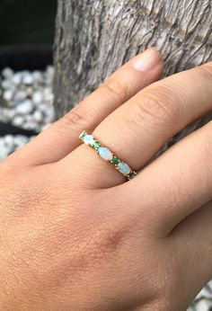 Opal and Emerald Half Eternity Matching Band Ring. Material: Solid Gold or PLATINUM Finishing: High Polished, Shiny Fit: Standard Width: 3.2 mm Height: 3 mm Setting: Prong Stone #1: Natural Opal Shape: Oval Size: 3mm x 5mm Quantity: 5 Opals Stone #2: Natural Emerald Quality: AAA Cut: Round, Diamond Cut Size: 2mm Quantity: 4 Emeralds This band will turn your Engagement Solitaire into a Sophisticated Wedding Set (Bridal Set). It will make your Solitaire Ring to pop out and look more eye catchy and Oval 14k Gold Eternity Band, Green Gemstone Eternity Band For Wedding, Oval Stackable Birthstone Ring In Fine Jewelry Style, Oval Birthstone Stackable Ring In Fine Jewelry Style, Heirloom Style Oval Diamond Stackable Ring, Heirloom Style Oval Stackable Diamond Ring, Heirloom Oval Diamond Ring Stackable, Fine Jewelry Oval Stackable Rings With Prong Setting, Yellow Gold Oval Stackable Rings With Halo