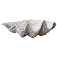 a large white bowl with wavy designs on the bottom and sides, set against a white background