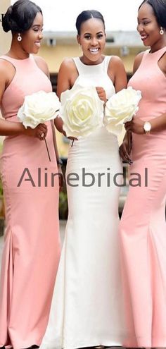 three beautiful women in pink dresses posing for the camera with one holding a white rose