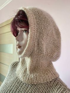 a mannequin's head wearing a knitted hood