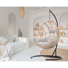 a white living room with a hanging chair