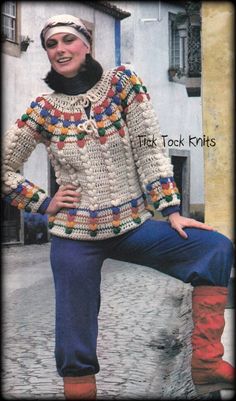 a woman is posing for a photo in her crocheted sweater and boots,