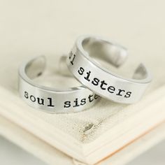 "This Soul Sisters Ring Set is stamped by hand, one letter at a time on 1/4\" wide aluminum blanks and wrapped by hand to fit your size. Please avoid contact with water to keep the black in the lettering and designs from fading. Our rings are made out of Pure 1100 Aluminum, which is food safe and does not tarnish. They contain no Zinc or Magnesium which are often found in common aluminum and can cause skin reactions. This also means it doesn't contain the properties of other metals that might ta Personalized Silver Friendship Rings, Adjustable Inspirational Stamped Rings, Personalized Adjustable Rings For Friendship, Adjustable Personalized Rings For Friendship, Meaningful Silver Jewelry With Custom Text, Country Best Friends, Bff Rings, Best Friend Rings, Sister Rings