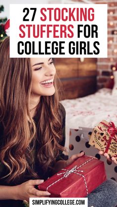 a woman holding a gift box with the words 27 stocking stuff for college girls