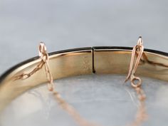 The detail on this antique bangle is stunning! Intricate maple leaf designs are engraved in warm rose gold, covering the entire bracelet. Beautiful on its own or layered with other bracelets this piece is perfect for day or evening wear. Metal: 10K Antique Rose Gold Width: 5.0 mm Inside Circumference: 6 Inches Marks: "10K" Stamped on the clasp Antique Gold Bangle, Bracelet Stacking, Leaf Designs, Leaf Motif, Cameo Ring, Jewelry Birthday, Antique Roses, Gold Bangle, Gold Bangle Bracelet