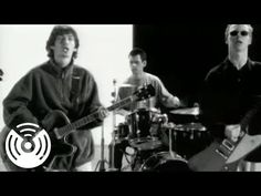 black and white photo of three men playing guitars