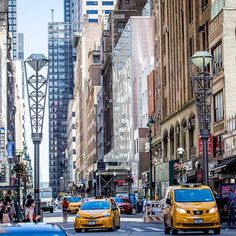 taxi cabs and pedestrians on a busy city street