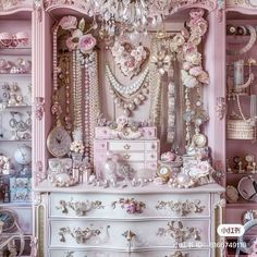 a pink and white dresser with lots of jewelry on it's shelves in a room