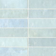 a white tiled wall with blue and gray tiles