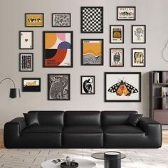 a living room filled with black leather furniture and pictures on the wall above it's coffee table