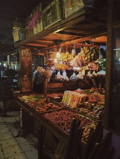 an outdoor market with lots of food on display