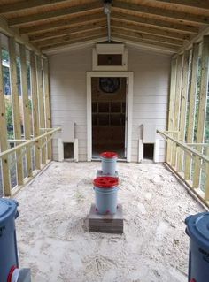 two buckets are sitting in the middle of a room with wood framing on it