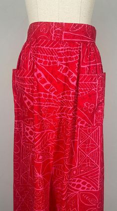 Exquisite 1970s maxi skirt in vivid shades of pink and red!  Hand-made from medium weight  cotton (or possibly poly-cotton blend)  from Polynesian fabric, this skirt is the perfect addition to your summer wardrobe. Pair with simple t-shirts for day time or slip on a cami for simple night time glam. Full skirt with gathering at sides and back of garment. Features  include sweet square pockets on front, thick waistband,  working metal zip, and 3 eyelet closure in excellent working order. A happy skirt for an even happier summer! MATERIALS: Outer: Medium weight cotton or possibly polycotton blend Inner: Unlined  MEASUREMENTS:  The garment is laid flat and measured (unstretched) from one side of the garment to the other.  Please double the below measurements, unless otherwise stated. WAIST: 34 Simple Tshirt, Happy Summer, Full Skirt, Vintage 70s, Summer Wardrobe, Maxi Skirt, Womens Skirt, Halloween Shopping, Cotton Blend