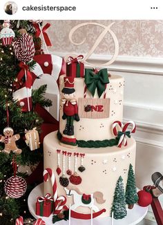 a three tiered cake decorated with christmas decorations