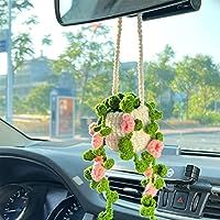 the interior of a car with flowers hanging from it's dash board and steering wheel