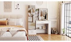 a bedroom with a bed, dresser and mirror in it's corner next to a sliding glass door