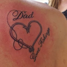 the back of a woman's shoulder with a heart and an arrow in it