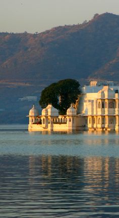 a large white building sitting on top of a lake