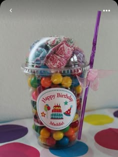 a jar filled with lots of candy on top of a table