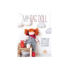 a red haired doll sitting on top of a wooden chair next to a book cover