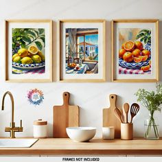 three framed pictures hanging on the wall above a kitchen counter with utensils and fruit