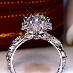 a close up view of a diamond ring with diamonds on the band and center stone