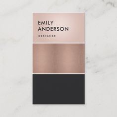 a business card with the name and color scheme in black, pink, gold and white