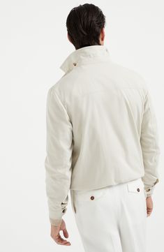 The combination of the cotton fibers with a small percentage of synthetic fibers makes the fabric fine and lightweight, but also resistant and ideal for providing protection during the summer months. The slightly shiny effect of the texture enhances the season's nuances and adds a sophisticated touch to the garment. Two-way zip closure Shirt-style collar Hand pockets with snap Adjustable button cuffs Elasticized hem Cupro lining Two interior pockets with button closure and pen holder Luxury Long Sleeve Cotton Outerwear, Luxury Cotton Outerwear With Pockets, Spring Cotton Track Jacket With Stand Collar, Classic Cotton Track Jacket For Spring, Classic Spring Cotton Track Jacket, Modern Cotton Outerwear With Ribbed Cuffs, Luxury Cotton Outerwear For Spring, Fitted Cotton Track Jacket With Pockets, Luxury Fitted Cotton Outerwear