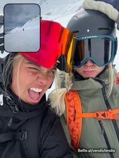 two people with ski goggles and snowboards on