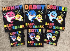 four baby shark t - shirts are on the floor with their name written in different colors