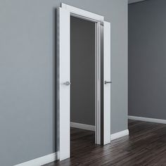 an empty room with two open doors on the wall and hard wood flooring in front of it