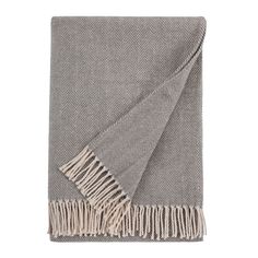 a grey and white blanket with fringes on it, folded in two different directions