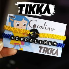 someone is holding up some bracelets with the name tika on it and an image of coraline