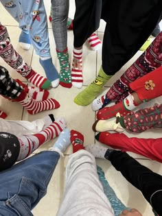 a group of people standing in a circle with their feet on the ground wearing christmas socks