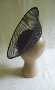 "One hat base with a 3.75\" tall upturned brim made in black stiffened sinamay straw that measures approximately 11\" (27.94 cm) in diameter at the top. The base is contoured to fit against the head. The edges of the brim are finished in sinamay. The multi-layer stiffened sinamay straw has a very delicate look but it has a great sturdy weave and provides excellent support for your millinery creations. This is NOT a finished hat and will not stay on your head unless you add a head band to wear. A Brimmed Sinamay Fascinator For Church, Fitted Sinamay Boater Hat With Short Brim, Fitted Black Straw Hat With Wide Brim, Fitted Wide Brim Sinamay Straw Hat, Kentucky Derby Fitted Sinamay Top Hat, Fitted Sinamay Fascinator For Church, Brimmed Mini Hat For Church In Sinamay, Black Fitted Costume Hat With Curved Brim, Church Brimmed Mini Hat In Sinamay